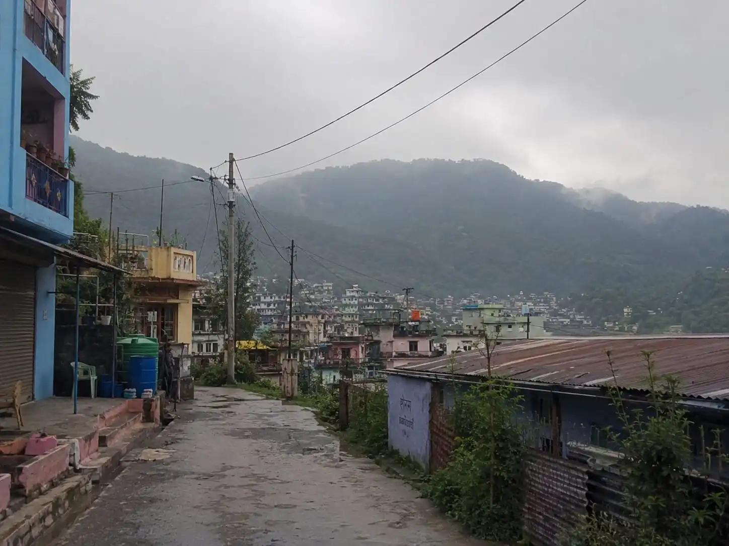 A quiet lane looking across a misty hill town